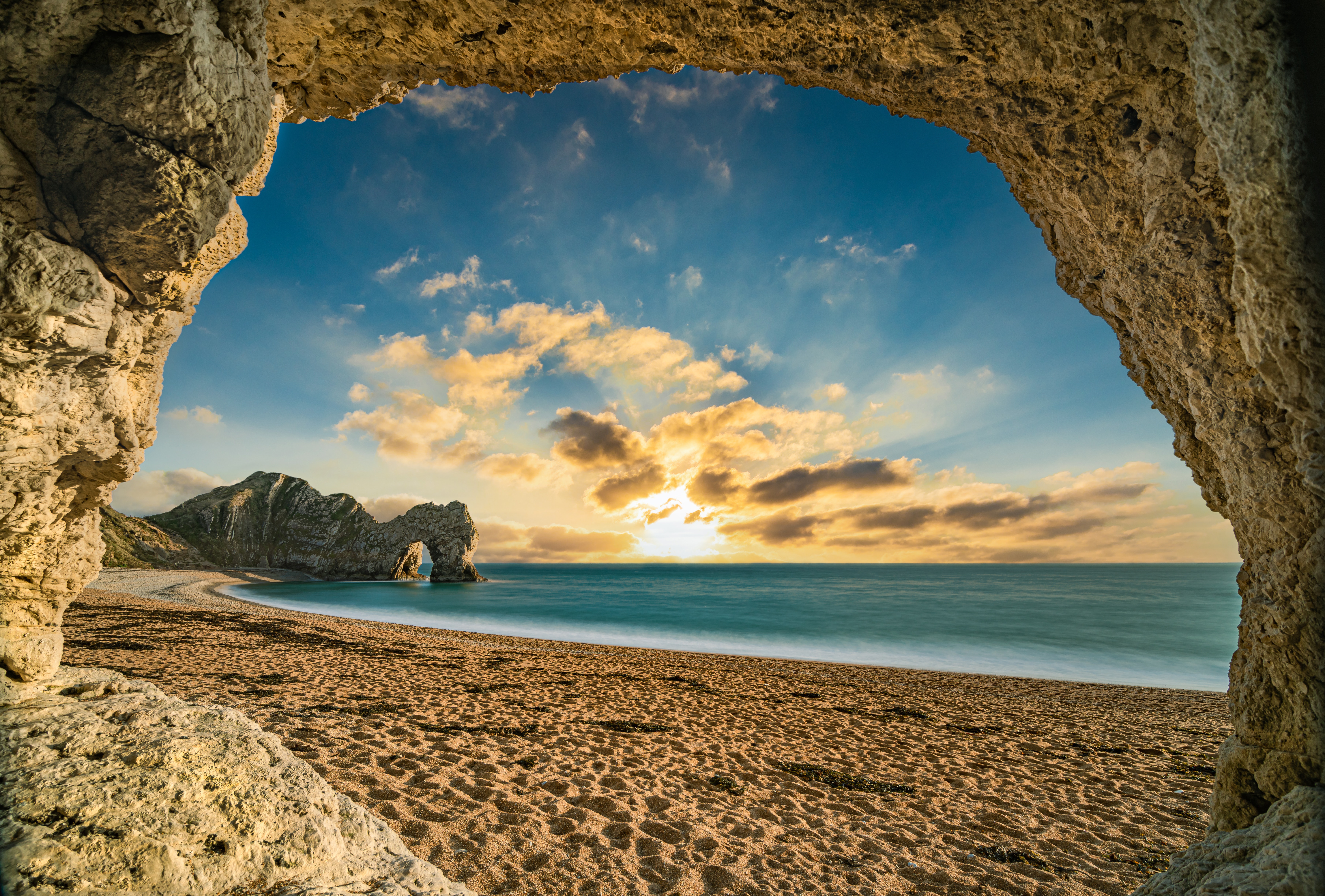 stunning view from a cave in durdle door sunset